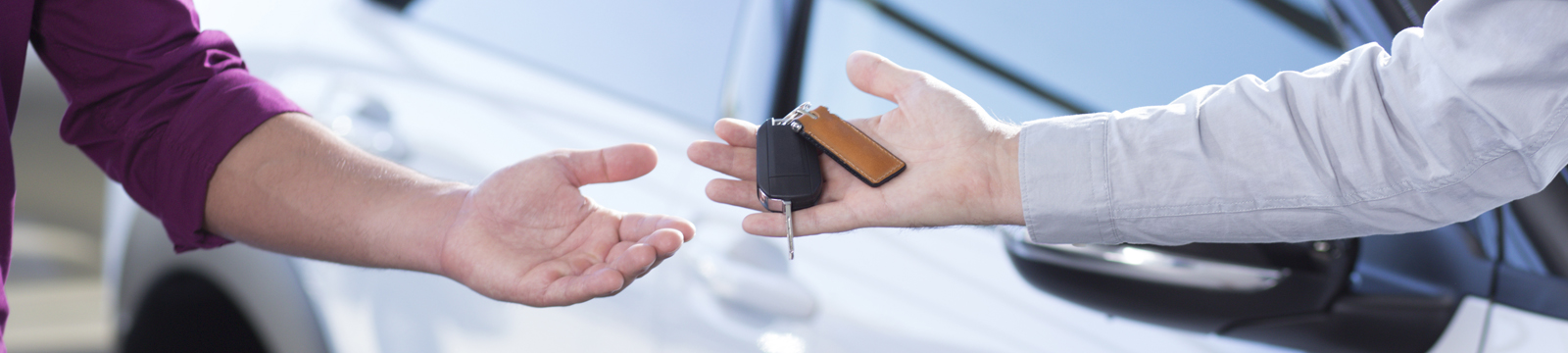 New car buyer receiving keys.