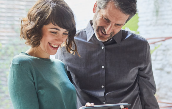 Young professional colleagues viewing tablet